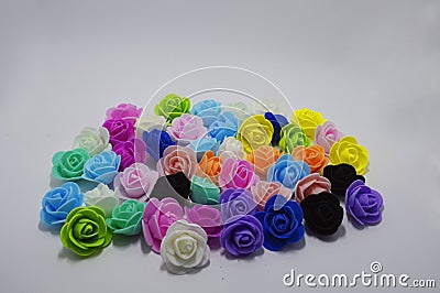 Multicolored artificial roses on a white background Stock Photo