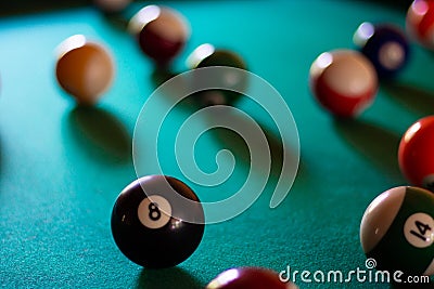 Multicolored billiard balls with numbers on the pool table. Sports game billiards on a green cloth Stock Photo
