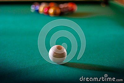 Multicolored billiard balls with numbers on the pool table. Sports game billiards on a green cloth. Copy space. Stock Photo
