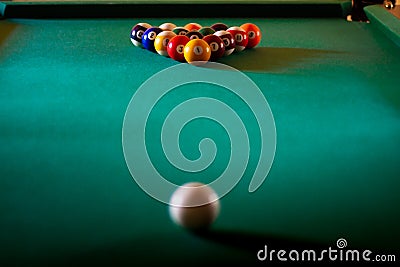 Multicolored billiard balls with numbers on the pool table. Sports game billiards on a green cloth. Copy space. Stock Photo