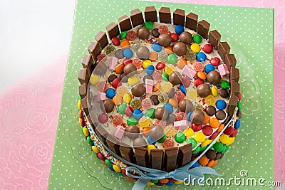 Multicolored birthday Pinata cake stuffed with sweets inside. Stock Photo