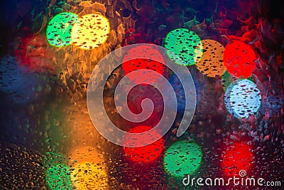 Multicolored blurred bokeh on the rain-soaked glass Stock Photo