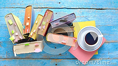 Multicolored books, cup of coffee, flat lay on old wooden desk, reading, education, literature, learning Stock Photo