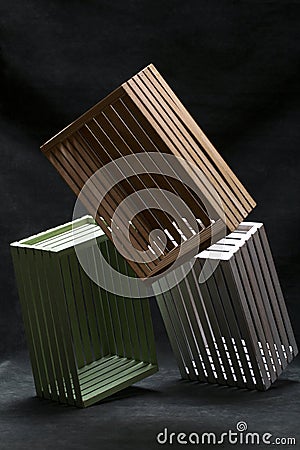 Multicolored boxes made of wooden slats on a dark background Stock Photo