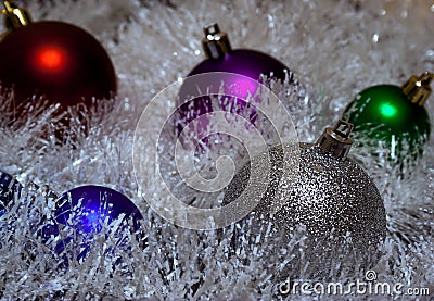 Multicolored Christmas balls in tinsel Stock Photo