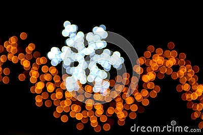 Snowflake made of ligths blurred on a black background Stock Photo