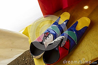 multicolored clown shoes backstage at a circus Stock Photo