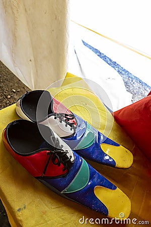 multicolored clown shoes backstage at a circus Stock Photo