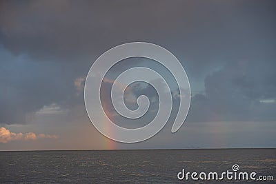 multicolored, colored rainbow after the rain hanging over the sea a Stock Photo