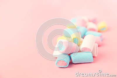 Multicolored colored vibrant marshmallows on a pink background. the concept of childhood Stock Photo