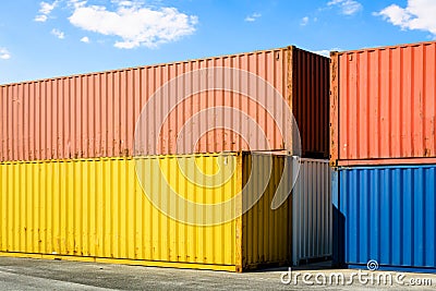 Multicolored containers stacked in an industrial park Stock Photo