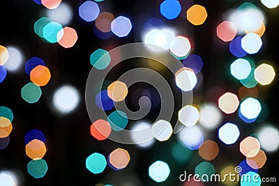 Multicolored festive lights on a black background screensaver backdrop Stock Photo