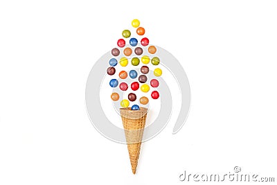 Multicolored hard shell chocolate candies and a wafer cone Stock Photo