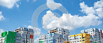 Multicolored houses panorama view. Blocked apartment buildings painted in vivid colors on blue sky background. Modern urban Stock Photo