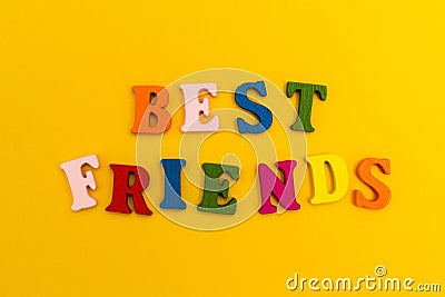 Multicolored letters on a yellow background. Best friends Stock Photo