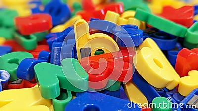 Shiny multicolored magnetic fridge letters of the alphabet mixed up Stock Photo