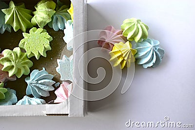 Multicolored meringue pieces on a white background Stock Photo