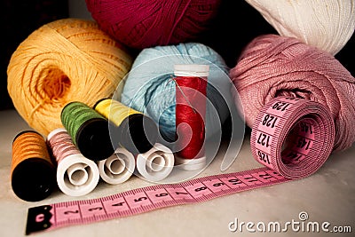 Multicolored objects of artisanal production such as: threads, needle and measuring tape. Stock Photo