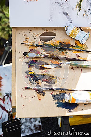 Multicolored paints and brushes for drawing, the artist`s workplace Stock Photo
