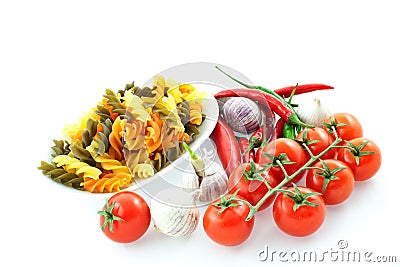 Multicolored pasta, pepper, tomato and garlic Stock Photo