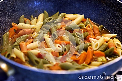 Multicolored pasta with vegetables Stock Photo