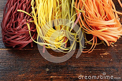 Multicolored pasta on wooden background Stock Photo