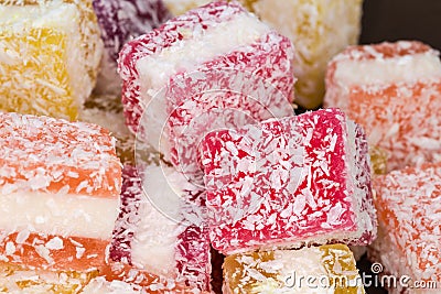 Multicolored piece jelly marmalade sprinkled with flaked coconut, close-up Stock Photo