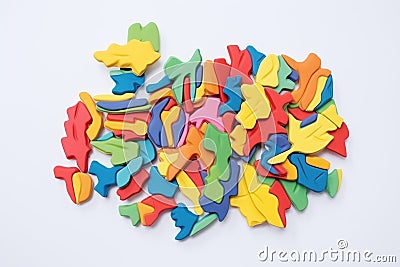 multicolored plasticine pieces puzzle on white surface Stock Photo