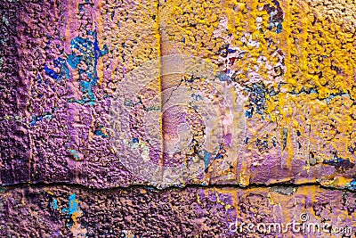 Multicolored purple orange graffiti close-up on rough concrete block wall texture Stock Photo