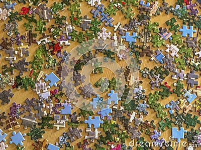 Multicolored puzzle elements on wooden table close-up. Top view. Copy space. Board games concept Stock Photo