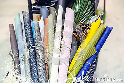 Multicolored rolled up linings napkins in the basket in the home decor accessories shop. Selective focus Stock Photo