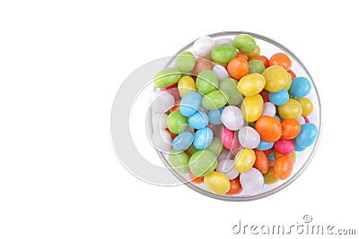 Multicolored round candy in a glass bowl on a white background. Isolated. Stock Photo