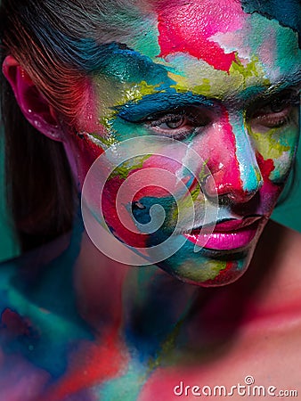 Multicolored skin, difficult to identify. Creative makeup with colorful patterns on the face. Stock Photo
