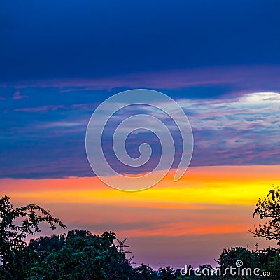 Multicolored sky over landscape at sunset Stock Photo