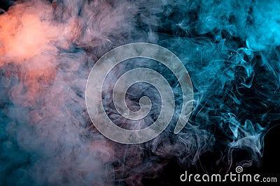 Multicolored smoke from a vape of blue and purple color of the strange mystical form on on a black isolated background. Bright Stock Photo