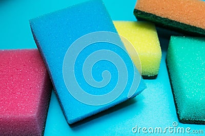 Multicolored sponges on a blue background Stock Photo