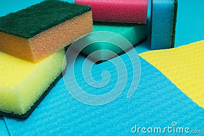 Multicolored sponges on a blue background Stock Photo