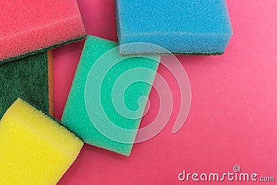 Multicolored sponges on a pink background Stock Photo