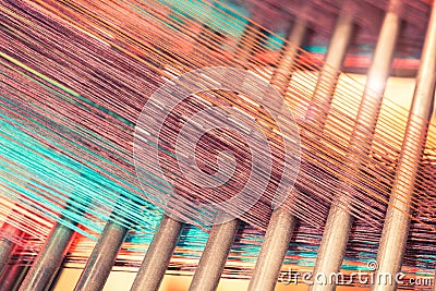 Multicolored straight strands texture background, sewing equipment, loom equipment at a garment factory Stock Photo