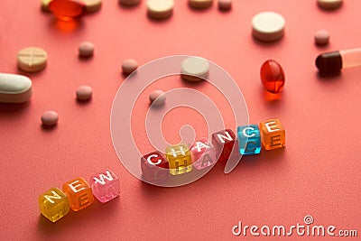 Multicolored title NEW CHANCE from transparent cubes on the table with tablets on coral background. Stock Photo