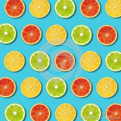 Multicolored vibrant citrus fruit slices texture on turquoise background Stock Photo