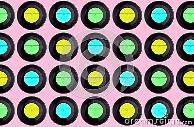 multicolored vinyl discs on a pink background Stock Photo