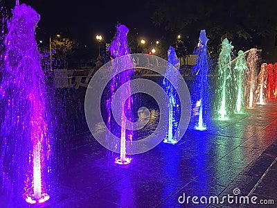 Multicolored Water Fountain Light Display at Night Stock Photo