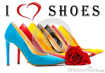 Multicolored women`s shoes with high heels standing in a row on a white surface with a red rose,Text I love shoes written in the Stock Photo