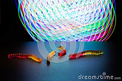 Multicolored worms made of gelatin against the background of multicolored Stock Photo