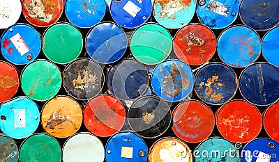 Multicolors old rusty oil barrels stack in rows Stock Photo