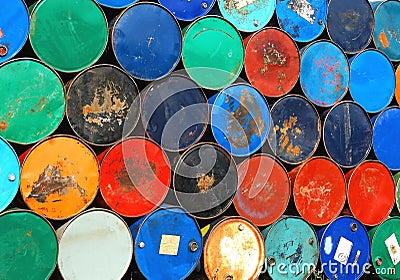 Multicolors old rusty oil barrels stack in rows Stock Photo