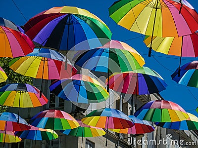 Multicolors umbrellas hunging in the street Stock Photo