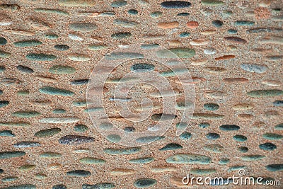 Multicolour pink, olive green, rusty red, gray, yellow ocher, blue natural pebble edges in dusty pink grey concrete Stock Photo