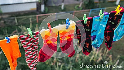 Multicoloured socks are dried on a string Stock Photo